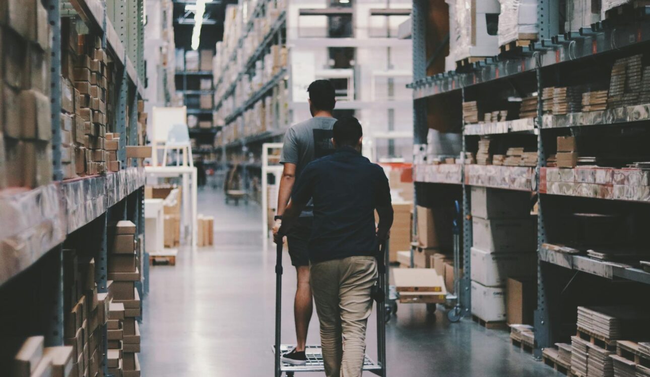 men going around a warehouse