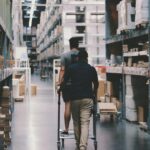 men going around a warehouse