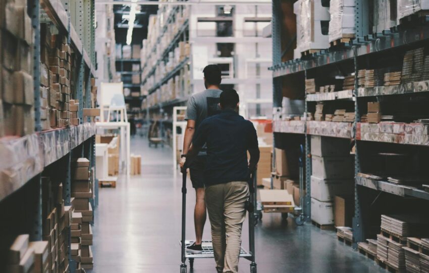 men going around a warehouse